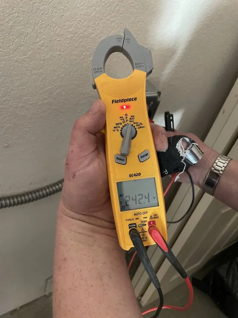 Voltage testing with clamp meter during Ceiling Fan Installation in James City
